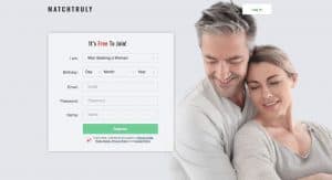 Smiling couple embracing next to dating signup form