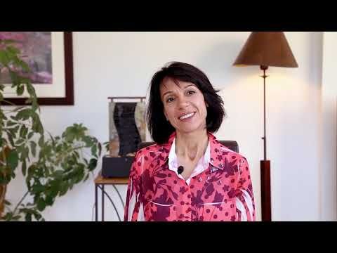 Smiling woman in pink floral blouse indoors