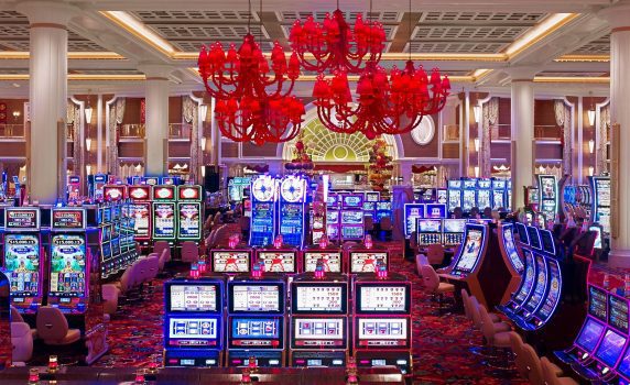 Casino floor with red chandeliers and slots