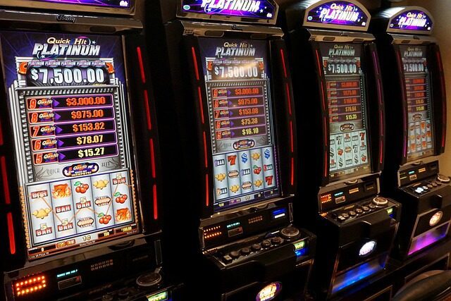 Row of illuminated casino slot machines
