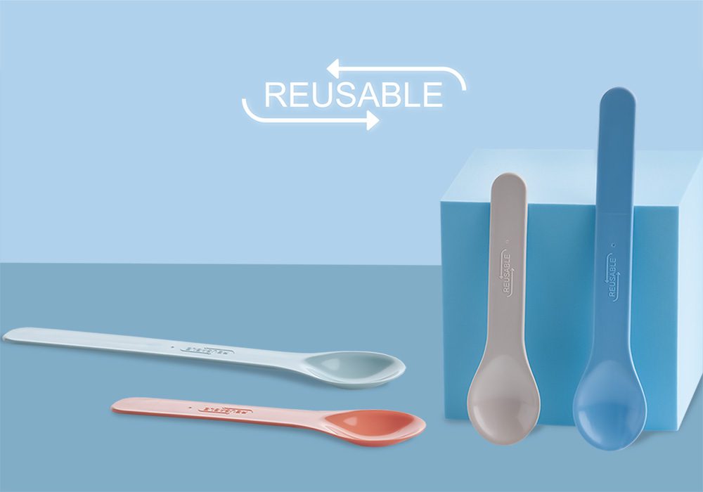 Set of pastel reusable spoons on blue background