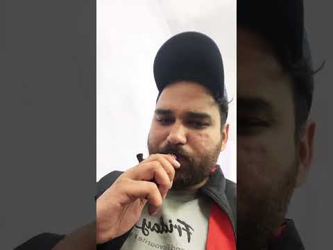Person vaping with cap and jacket