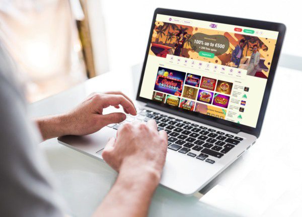 Person browsing online casino games on laptop