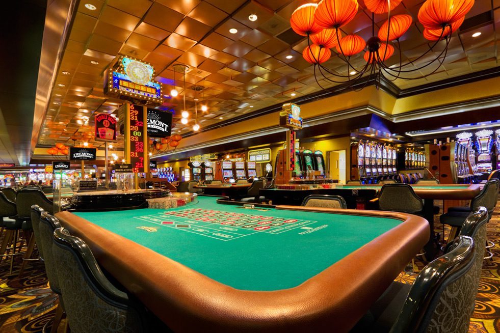 Empty casino gaming table and slot machines